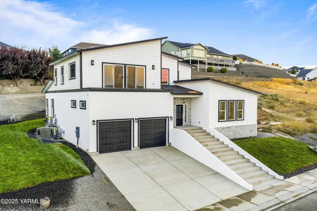 a front view of a house with a garden
