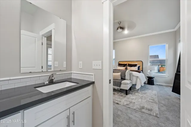 a en suite bathroom with a sink and mirror