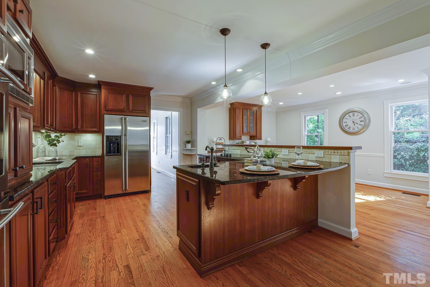 11709 Old Creedmoor Road Raleigh, NC 27613 - Photo 2 of 16 a kitchen with stainless steel appliances granite countertop wooden floors and sink