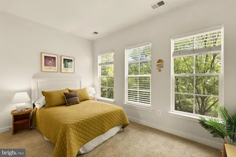 a bedroom with a bed and a potted plant