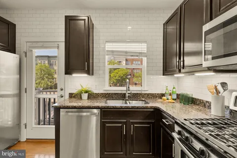 a kitchen with a sink stove and microwave
