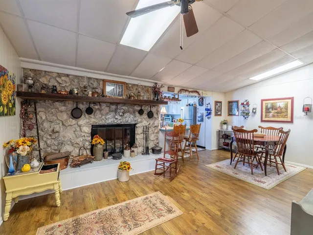 a view of a house with a yard and potted plants