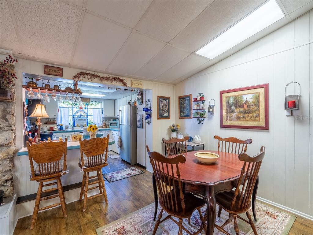 23560 Northeast 154th Place Road Salt Springs, FL 32134 - Photo 13 of 52 a dining room with a table and chairs