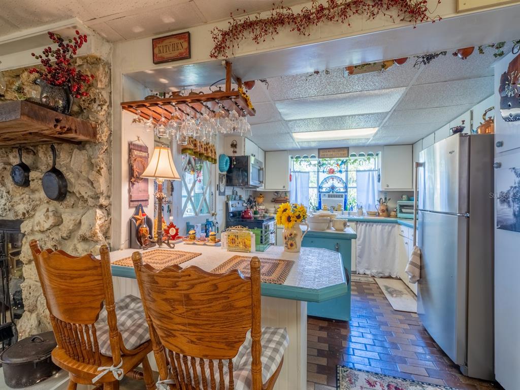 23560 Northeast 154th Place Road Salt Springs, FL 32134 - Photo 14 of 52 a view of a dining room with furniture window and wooden floor