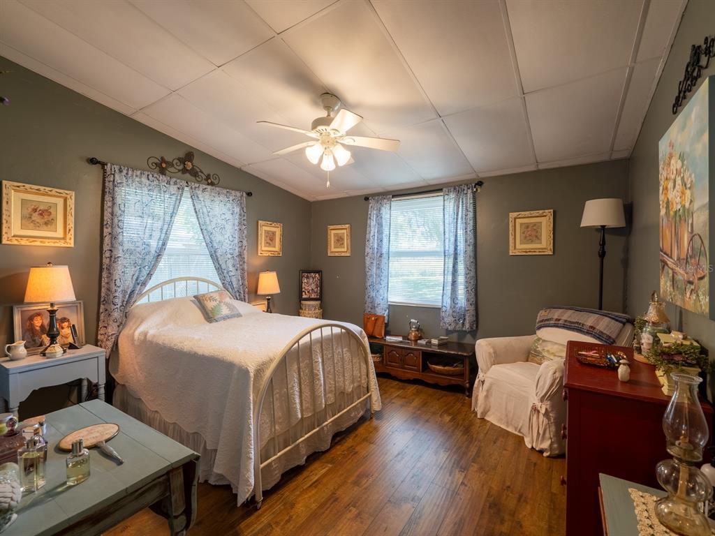 23560 Northeast 154th Place Road Salt Springs, FL 32134 - Photo 20 of 52 a bedroom with a bed and wooden floor