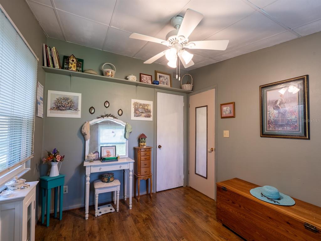 23560 Northeast 154th Place Road Salt Springs, FL 32134 - Photo 22 of 52 a view of a workspace with furniture and wooden floor