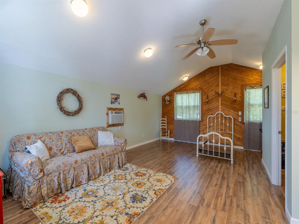 23560 Northeast 154th Place Road Salt Springs, FL 32134 - Photo 28 of 52 a living room with furniture and wooden floor