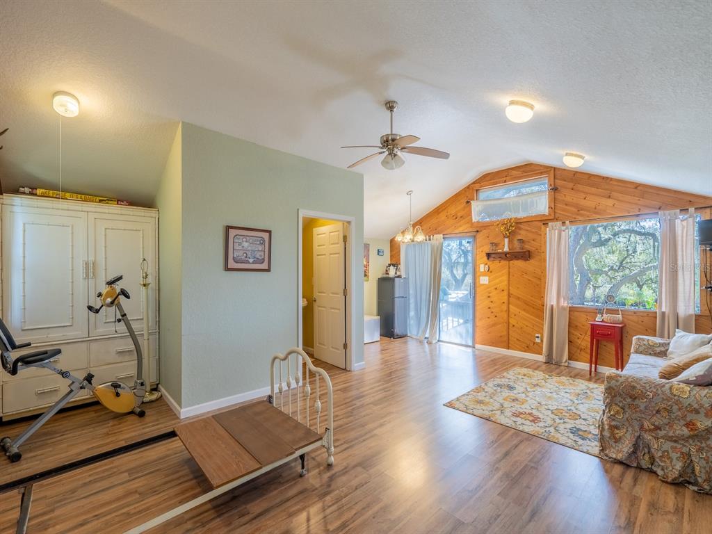 23560 Northeast 154th Place Road Salt Springs, FL 32134 - Photo 29 of 52 a living room with furniture and wooden floor