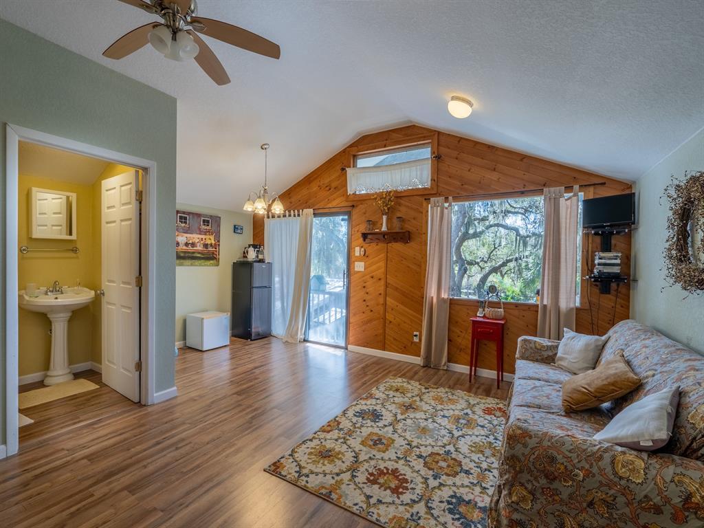 23560 Northeast 154th Place Road Salt Springs, FL 32134 - Photo 30 of 52 a view of a livingroom with furniture and a ceiling fan
