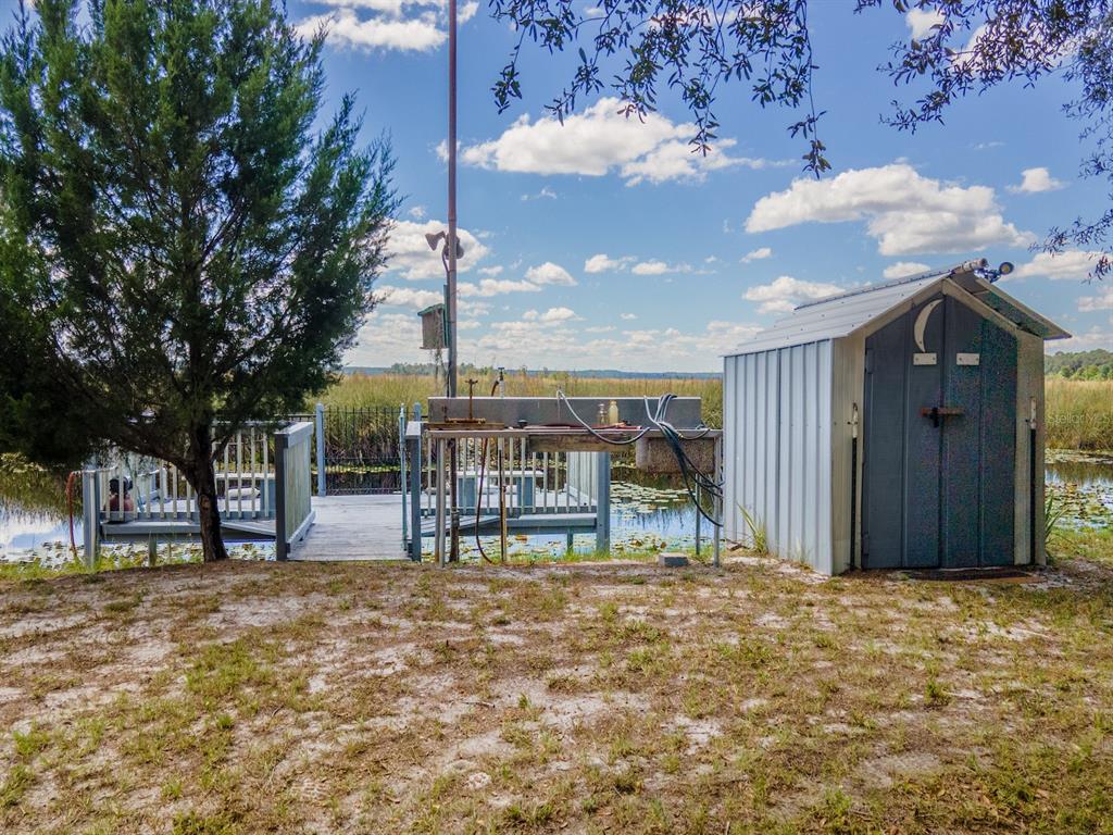 23560 Northeast 154th Place Road Salt Springs, FL 32134 - Photo 37 of 52 a view of a house with backyard porch and sitting area
