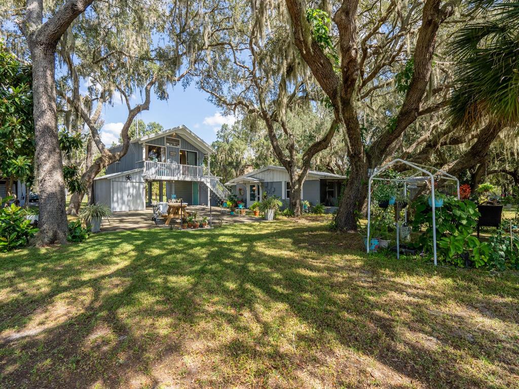23560 Northeast 154th Place Road Salt Springs, FL 32134 - Photo 40 of 52 a front view of a house with a garden