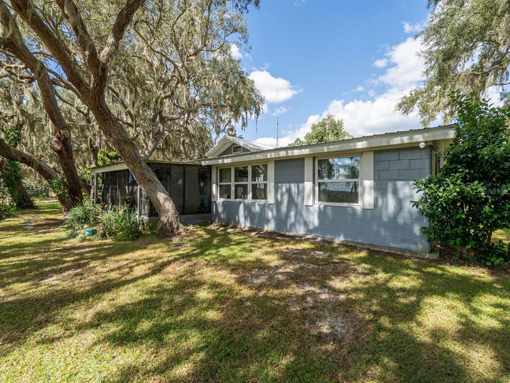 23560 Northeast 154th Place Road Salt Springs, FL 32134 - Photo 43 of 52 a view of a house with a yard and potted plants