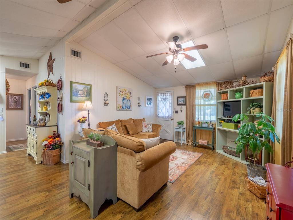 23560 Northeast 154th Place Road Salt Springs, FL 32134 - Photo 8 of 52 a living room with furniture and a bookshelf