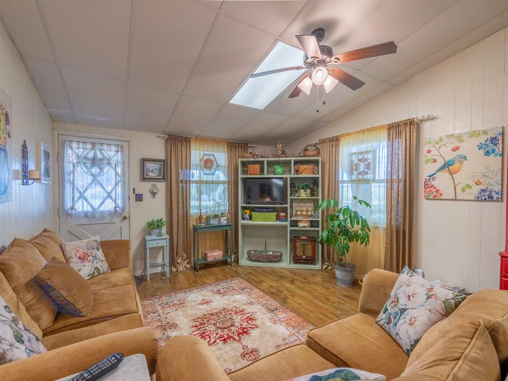 23560 Northeast 154th Place Road Salt Springs, FL 32134 - Photo 9 of 52 a bedroom with a large bed and a couch