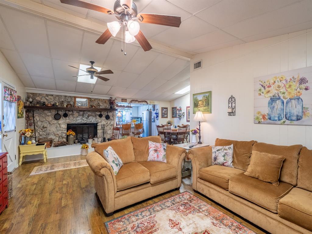 23560 Northeast 154th Place Road Salt Springs, FL 32134 - Photo 10 of 52 a living room with furniture a fireplace and a chandelier