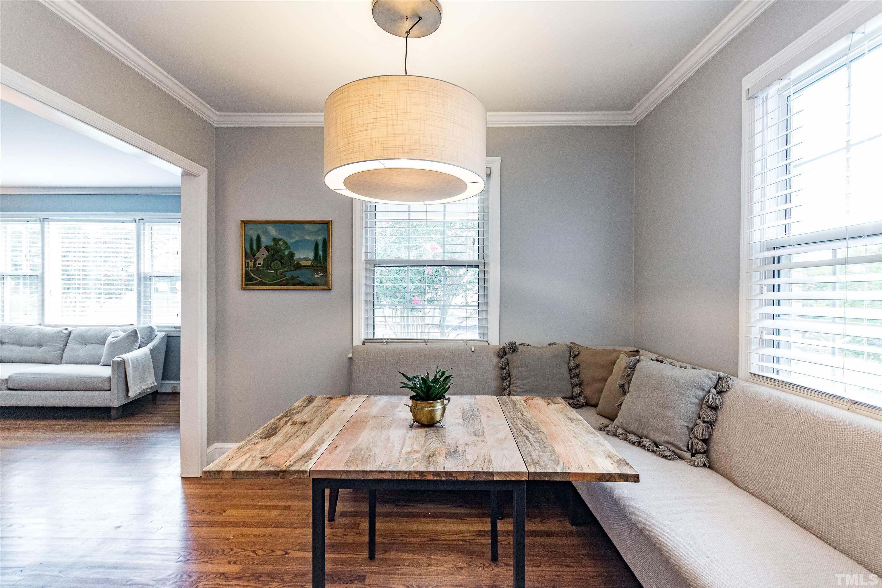 758 East Whitaker Mill Road Raleigh, NC 27608 - Photo 11 of 43 a view of a dining room with furniture window and wooden floor