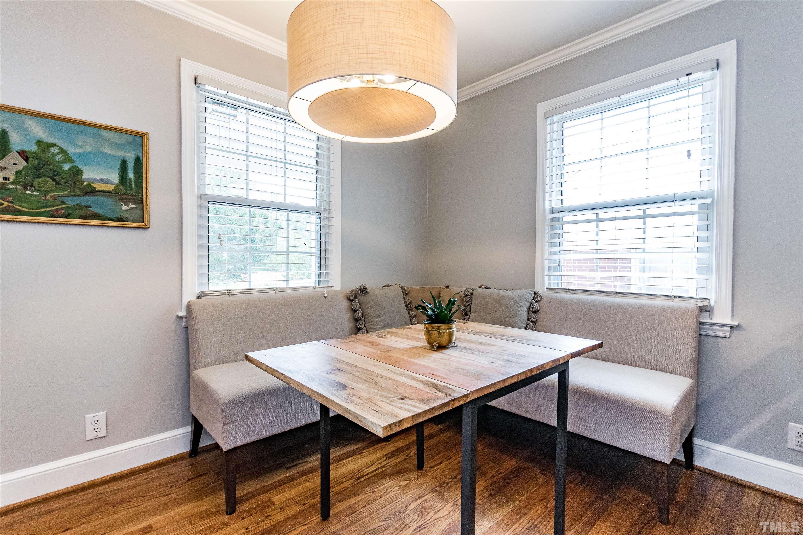 758 East Whitaker Mill Road Raleigh, NC 27608 - Photo 13 of 43 a view of a dining room with furniture window and wooden floor