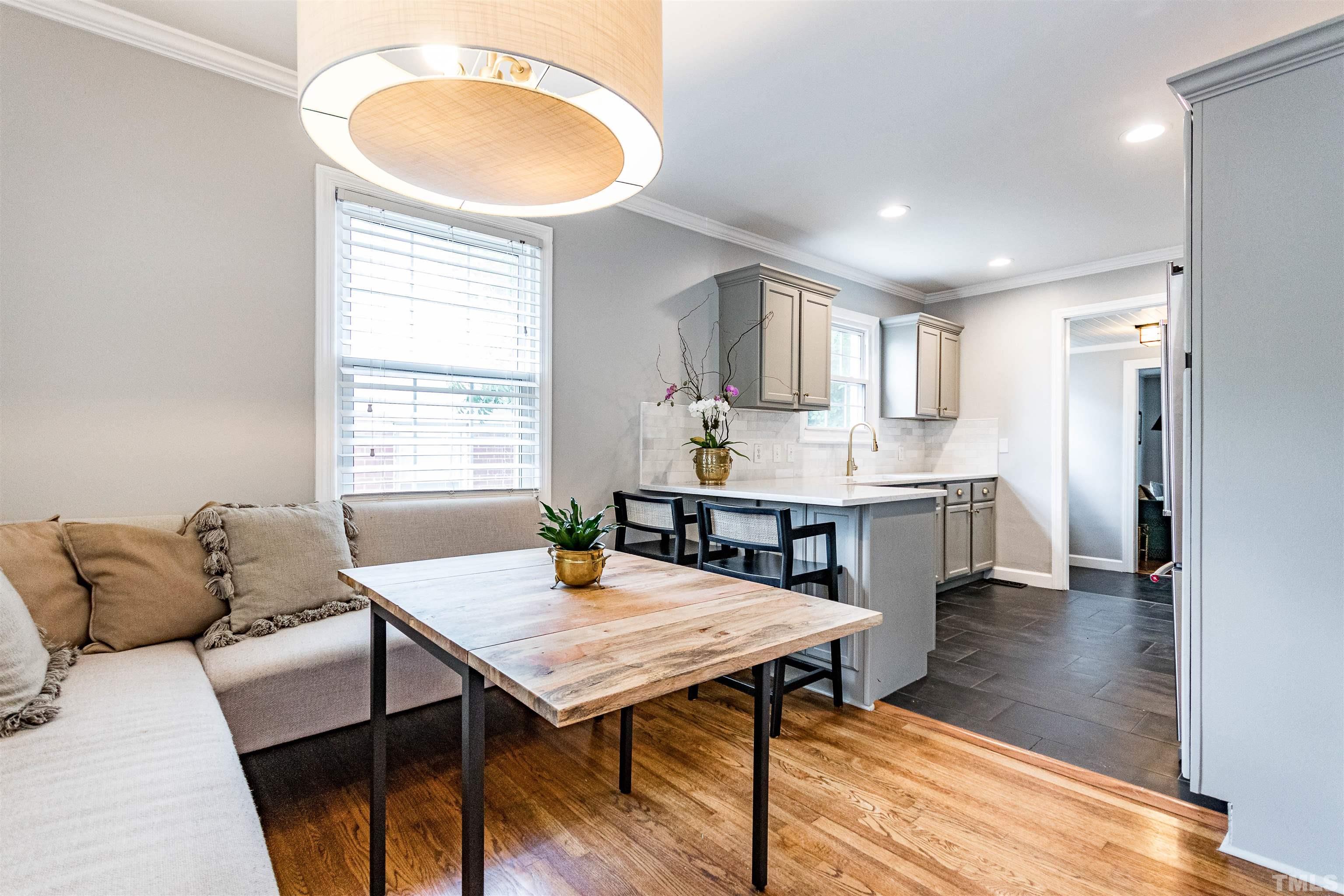 758 East Whitaker Mill Road Raleigh, NC 27608 - Photo 14 of 43 a living room with furniture and wooden floor