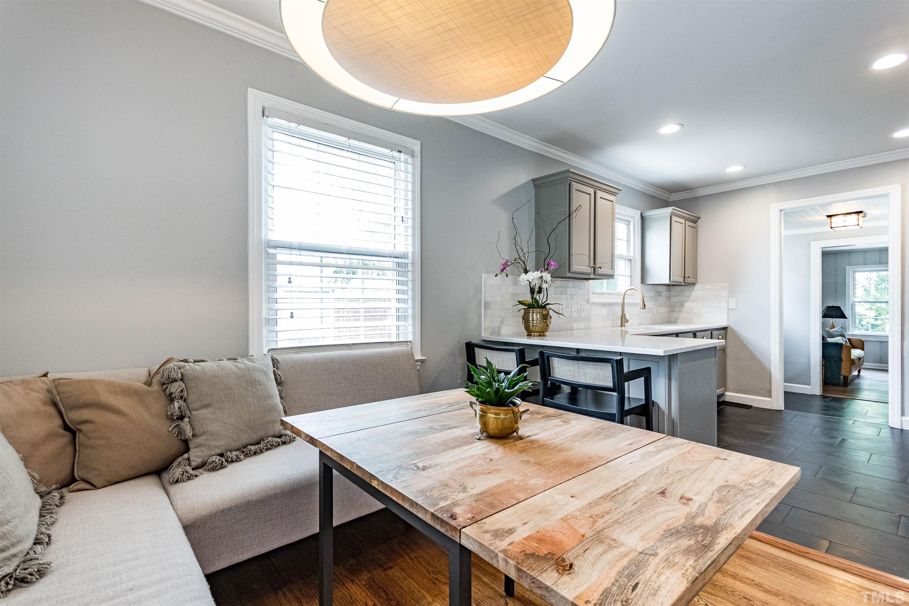 758 East Whitaker Mill Road Raleigh, NC 27608 - Photo 15 of 43 a living room with kitchen island furniture and a table