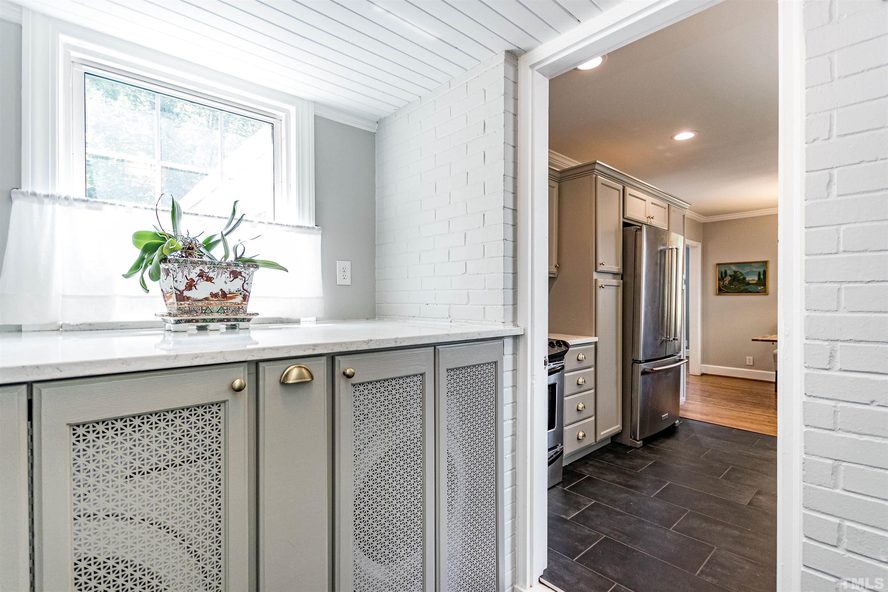 758 East Whitaker Mill Road Raleigh, NC 27608 - Photo 20 of 43 a bathroom with a granite countertop sink a large mirror a shower and a window