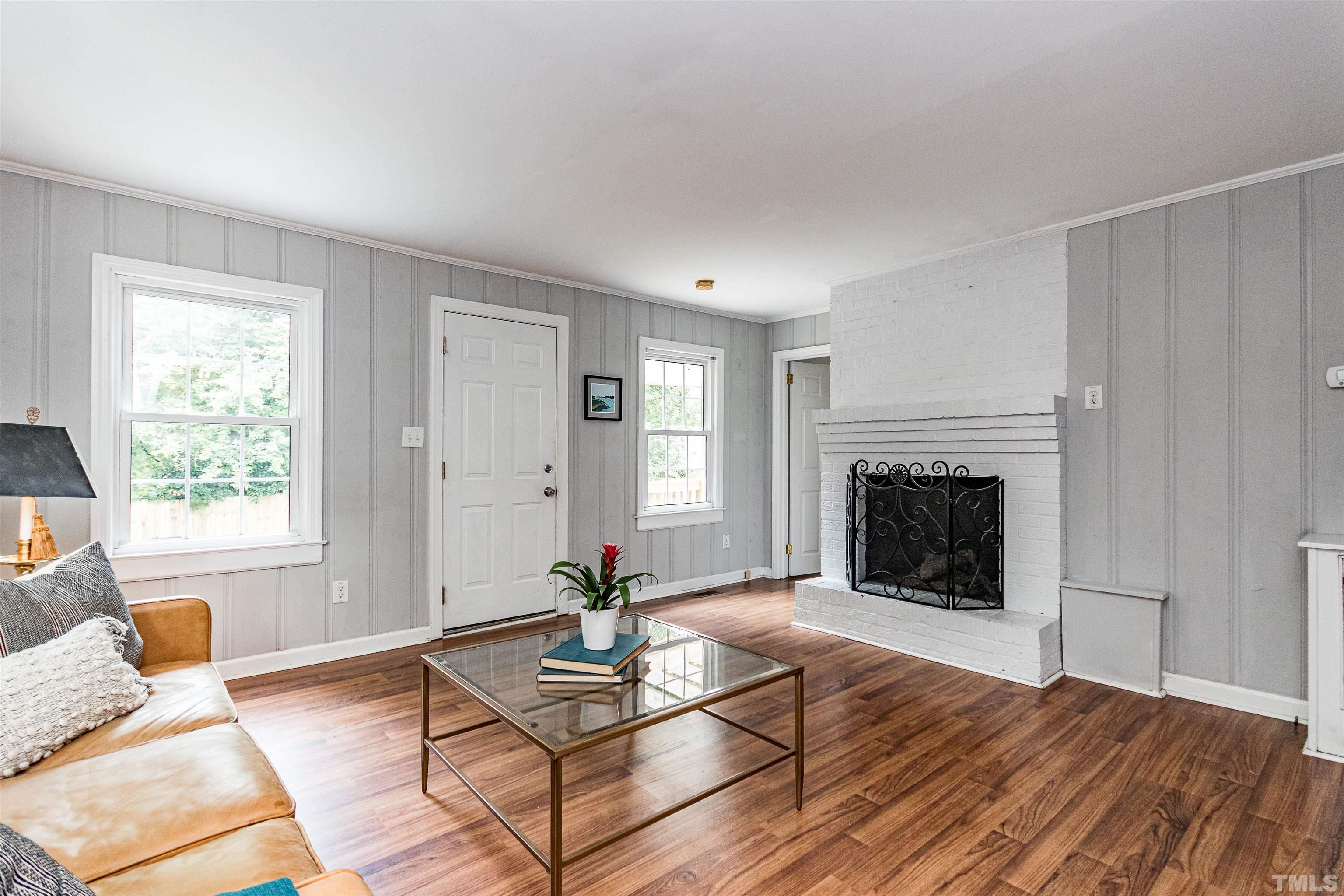 758 East Whitaker Mill Road Raleigh, NC 27608 - Photo 25 of 43 a living room with furniture a window and a fireplace
