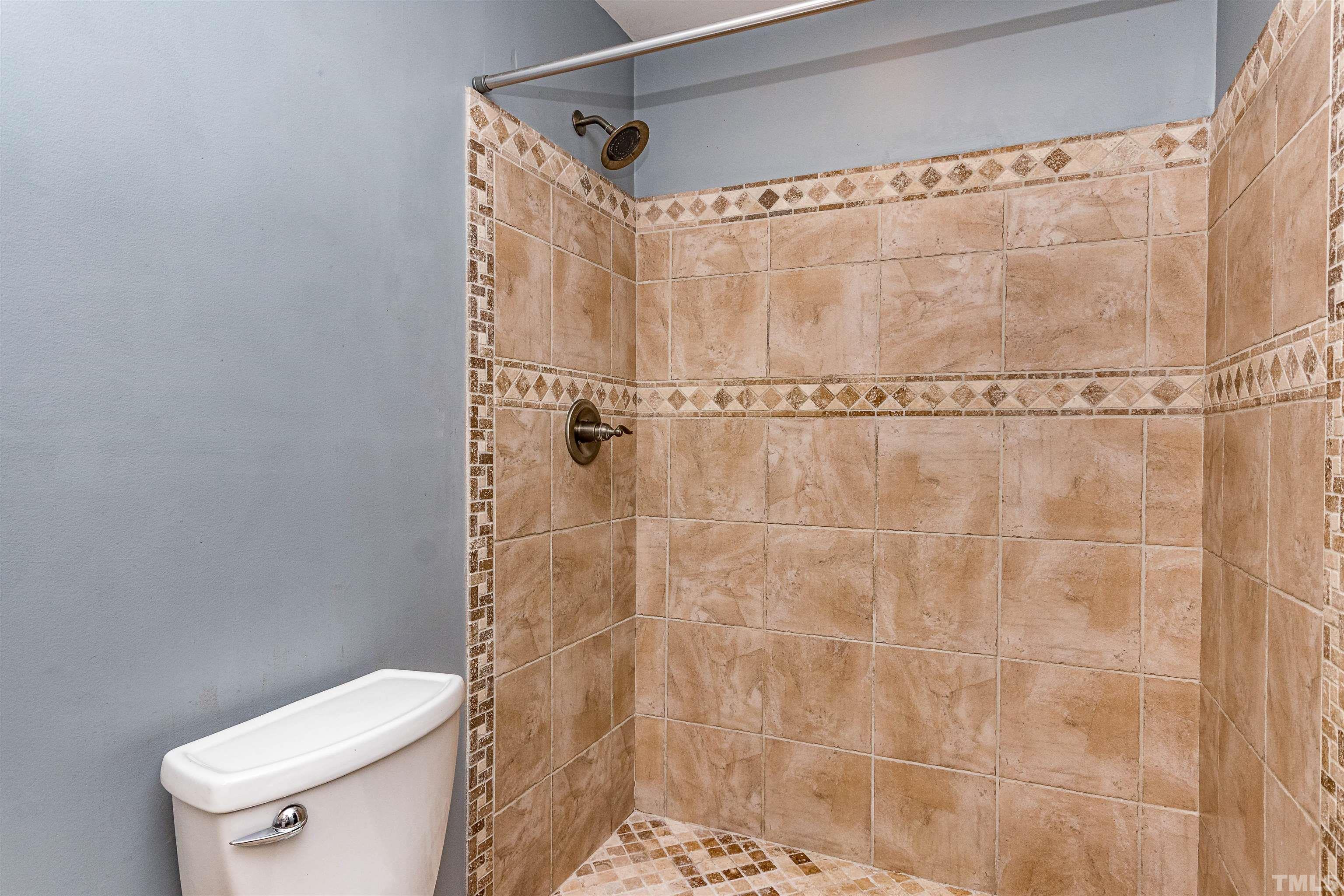 758 East Whitaker Mill Road Raleigh, NC 27608 - Photo 31 of 43 a bathroom with a shower and a toilet