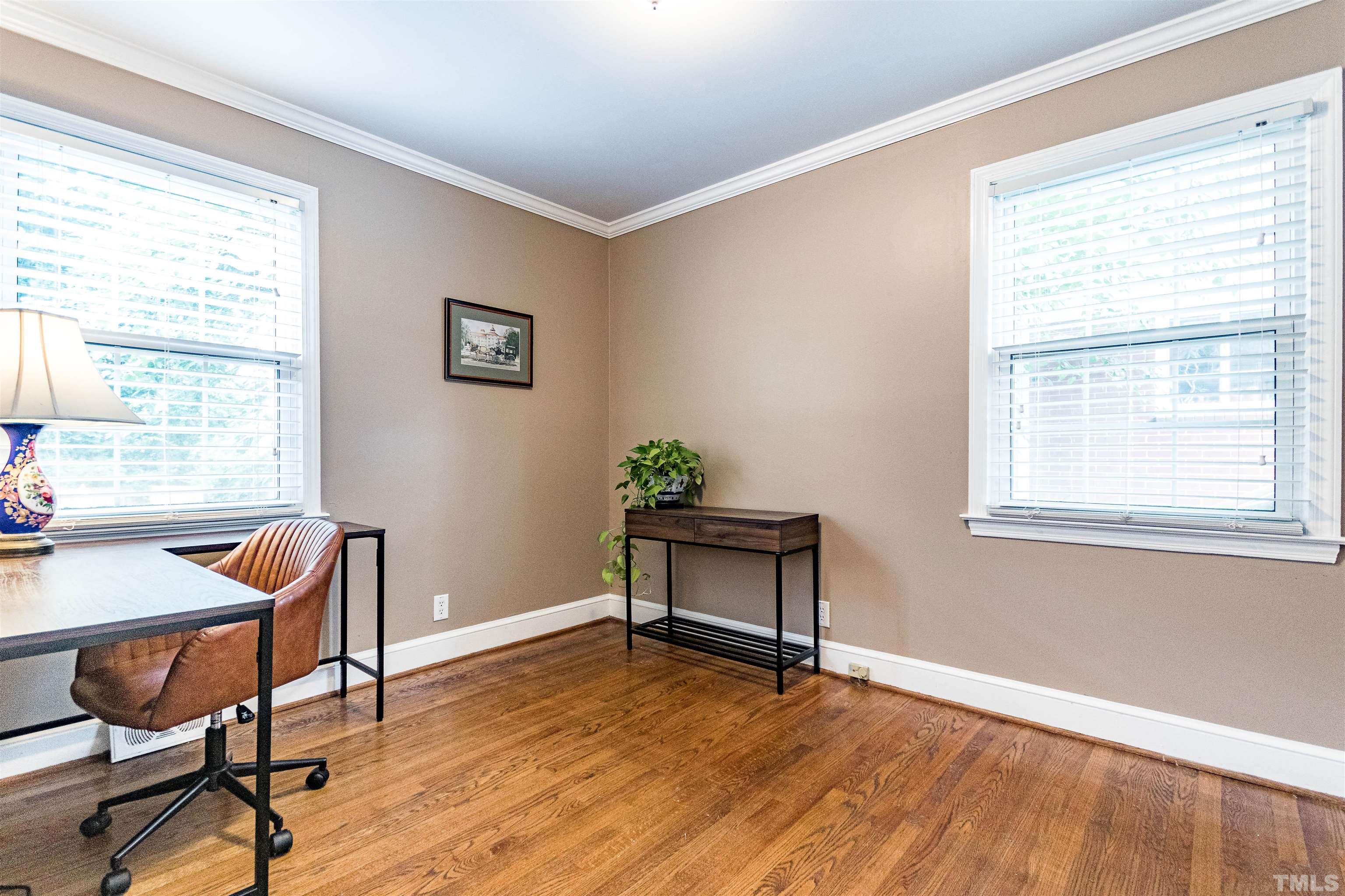 758 East Whitaker Mill Road Raleigh, NC 27608 - Photo 34 of 43 a view of a workspace with furniture and a window