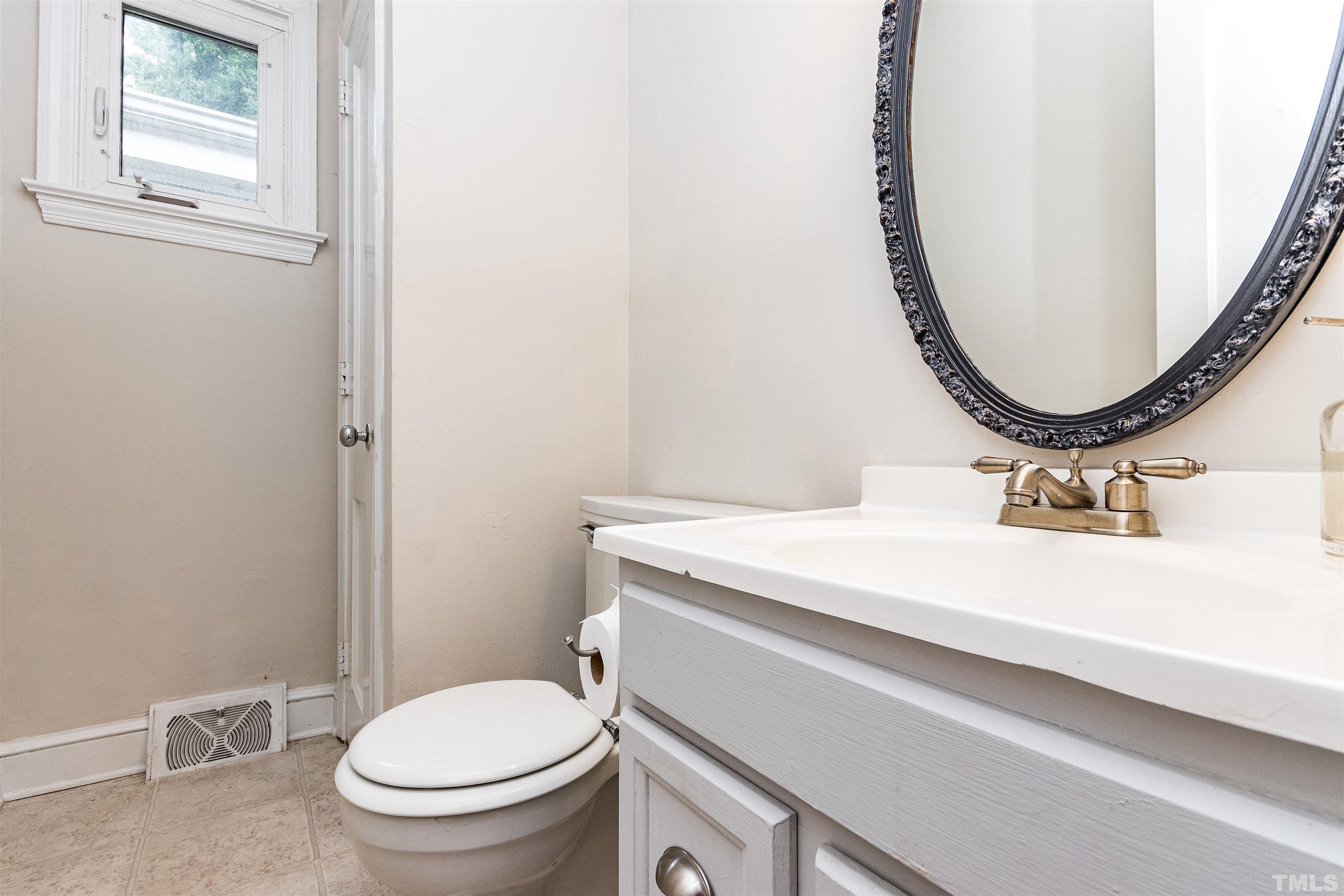 758 East Whitaker Mill Road Raleigh, NC 27608 - Photo 39 of 43 a bathroom with a sink and a mirror