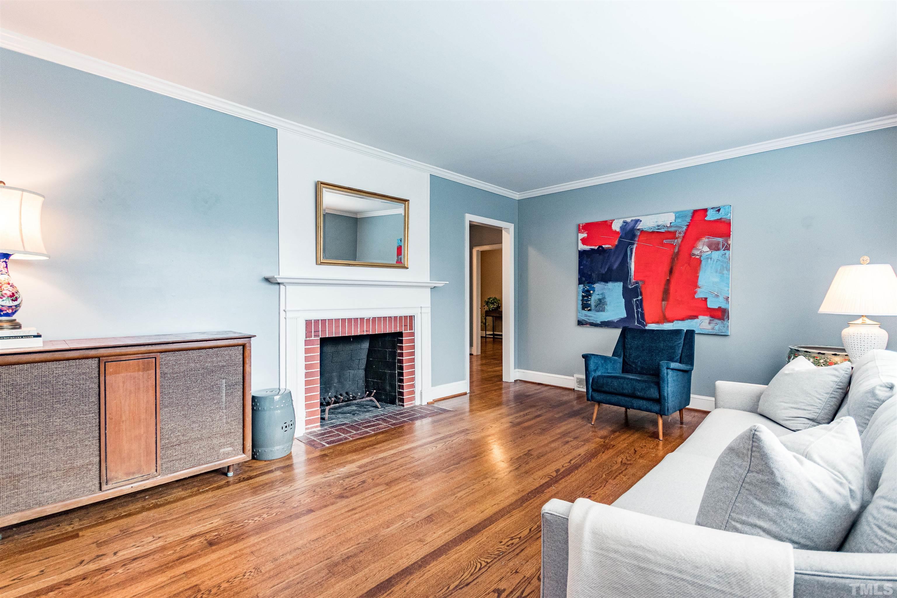 758 East Whitaker Mill Road Raleigh, NC 27608 - Photo 6 of 43 a living room with furniture and a fireplace