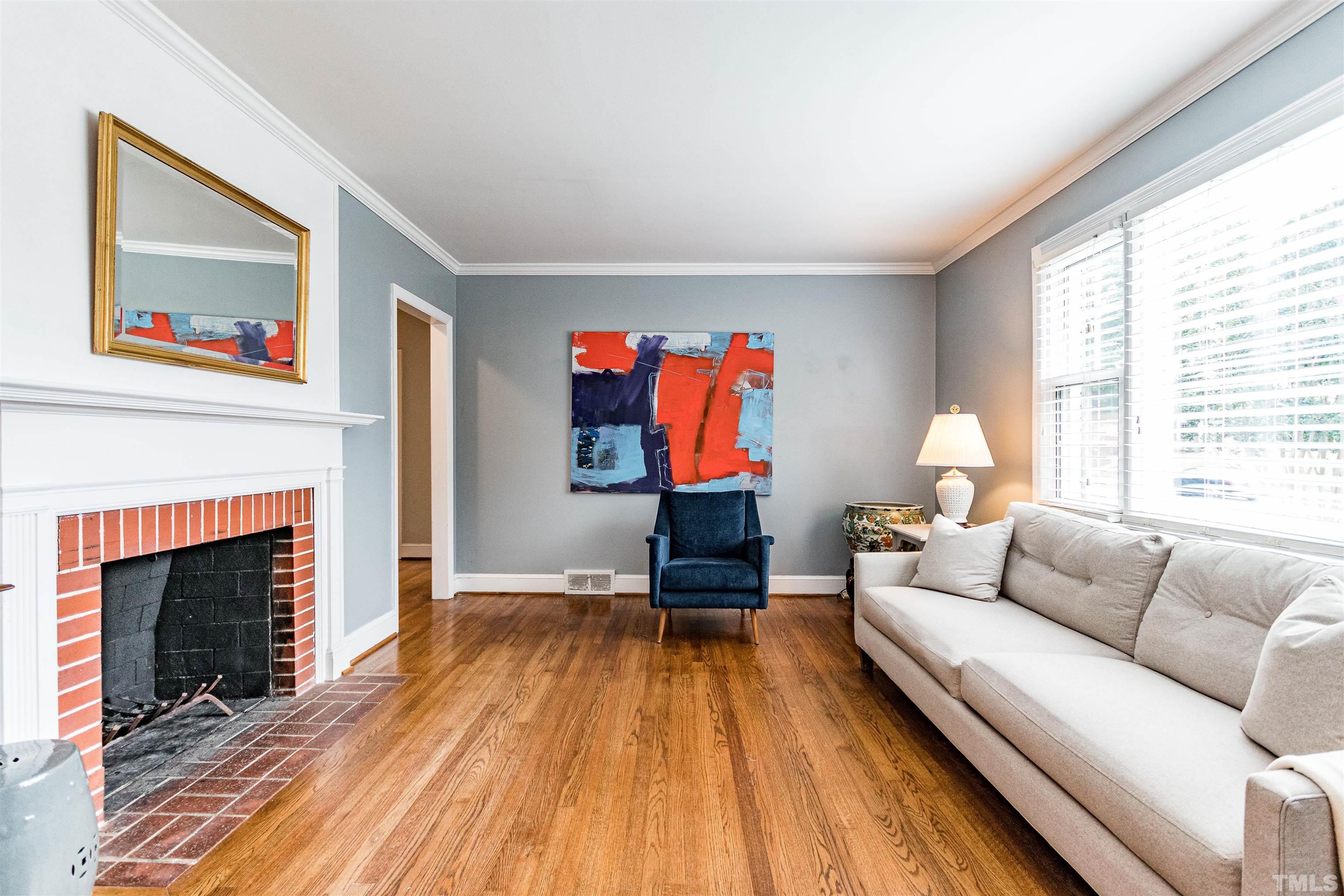 758 East Whitaker Mill Road Raleigh, NC 27608 - Photo 7 of 43 a living room with furniture a fireplace and a large window