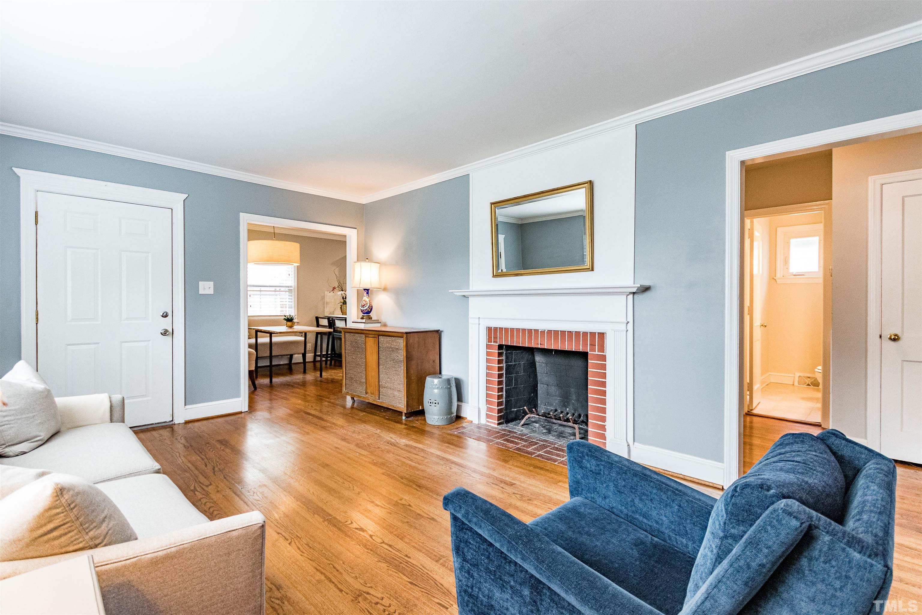 758 East Whitaker Mill Road Raleigh, NC 27608 - Photo 10 of 43 a living room with furniture and a fireplace