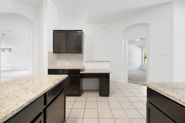 a kitchen with a sink and a stove top oven with wooden floor