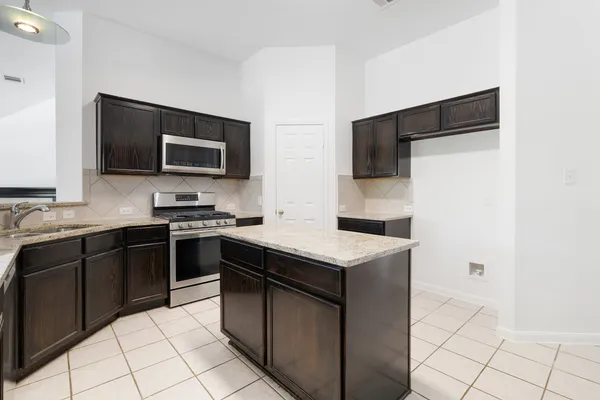 a kitchen with a sink and stainless steel appliances