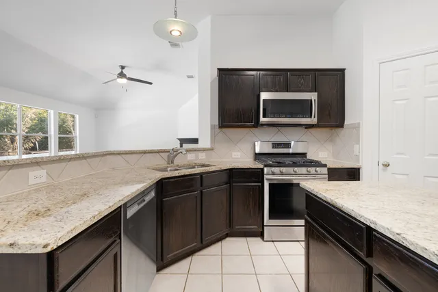 a kitchen with a sink and a stove top oven