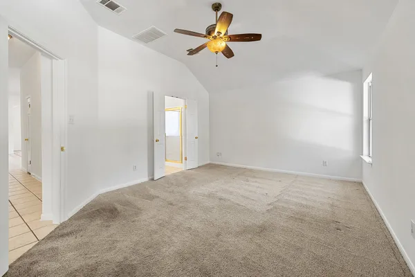 a view of room with a ceiling fan and a window