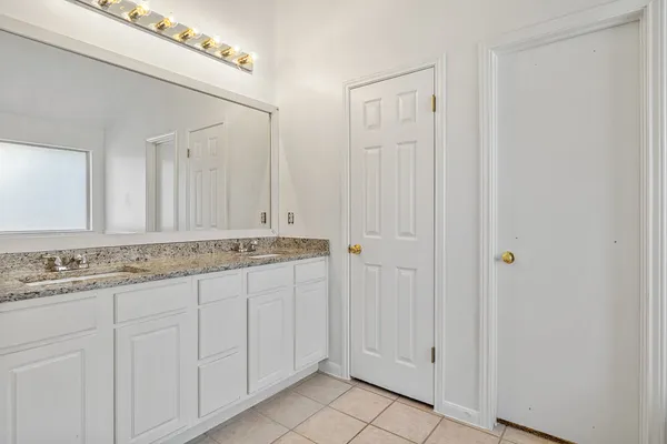a bathroom with a shower and a glass door