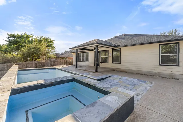 a view of a swimming pool with a patio