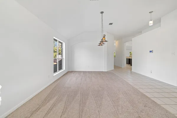 a view of a empty room with a fan