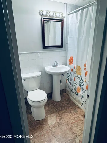 an empty room with wooden floor and closet