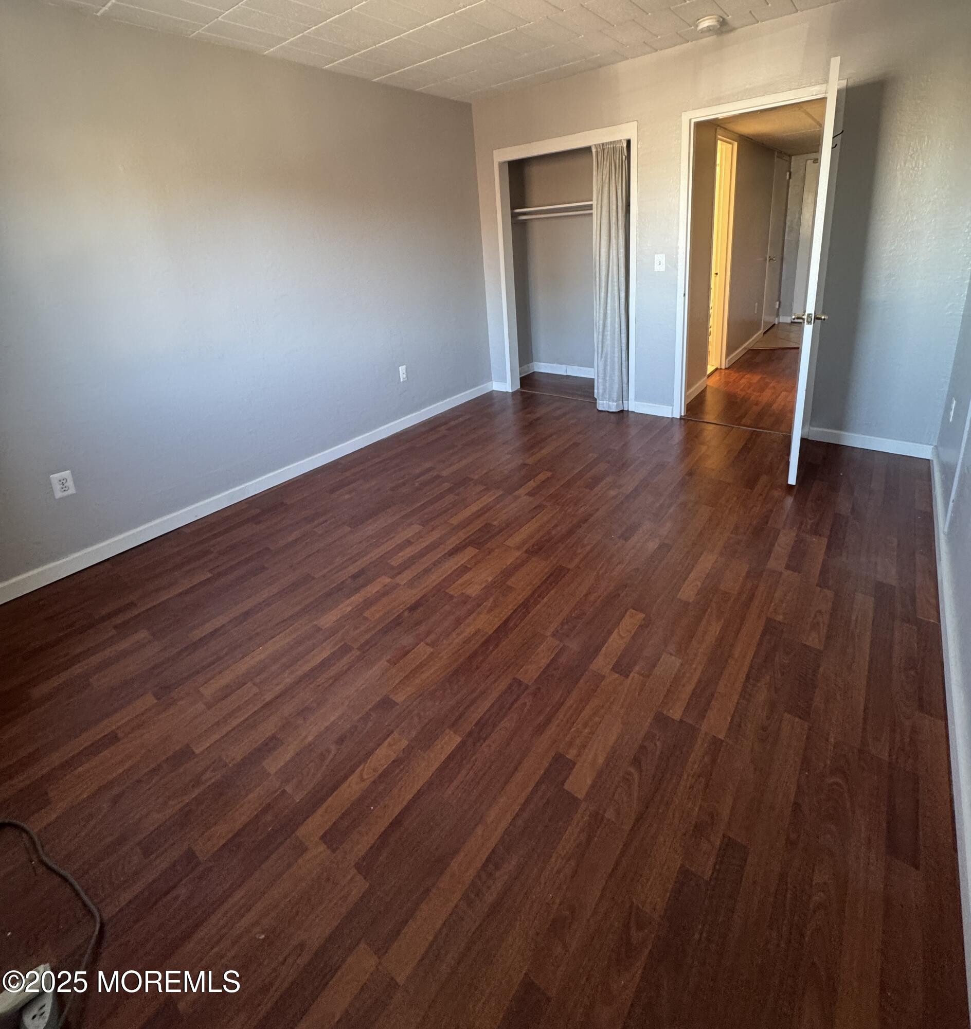 21 Leroy Place, Unit 3F Red Bank, NJ 07701 - Photo 14 of 17 a view of an empty room with wooden floor and closet
