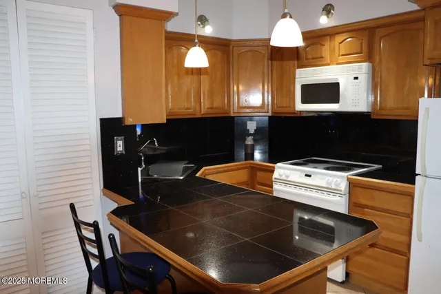 a kitchen with a stove and a microwave