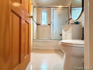 217-11 73rd Avenue, Unit 2 Queens, NY 11364 - Photo 12 of 21 a bathroom with a toilet a sink and a mirror