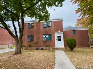 217-11 73rd Avenue, Unit 2 Queens, NY 11364 - Photo 18 of 21 front view of a house with a yard