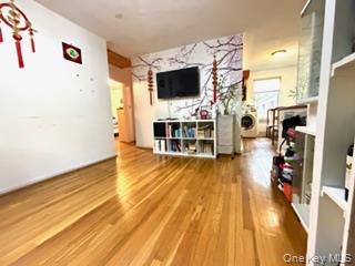 217-11 73rd Avenue, Unit 2 Queens, NY 11364 - Photo 4 of 21 a view of a living room hardwood floor and a flat screen tv