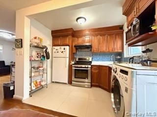 217-11 73rd Avenue, Unit 2 Queens, NY 11364 - Photo 6 of 21 a kitchen with a refrigerator and a sink