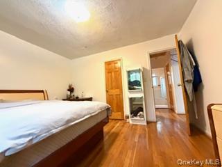 217-11 73rd Avenue, Unit 2 Queens, NY 11364 - Photo 9 of 21 a bedroom with a bed and a view of living room