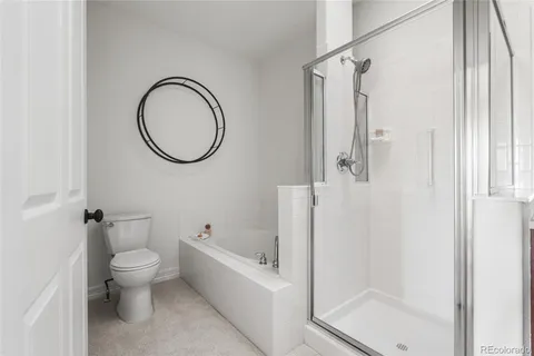 a bathroom with a toilet and a shower