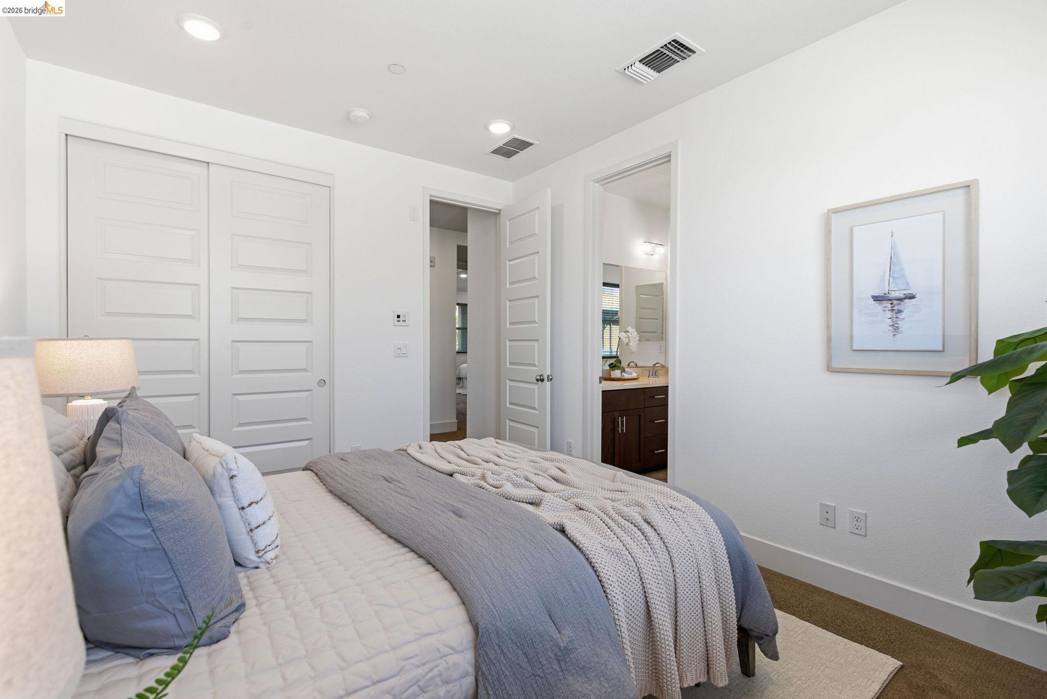 475 Mitchell Avenue Alameda, CA 94501 - Photo 19 of 40 a bedroom with a bed and a potted plant