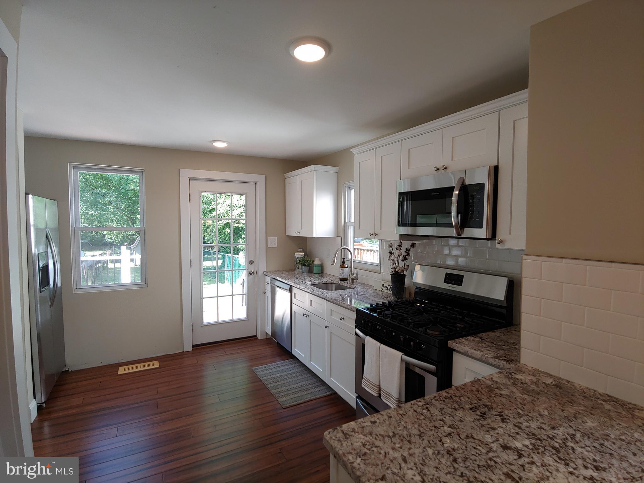 150 Rancocas Road Mount Holly, NJ 08060 - Photo 8 of 25 a kitchen with granite countertop a stove a sink and a microwave