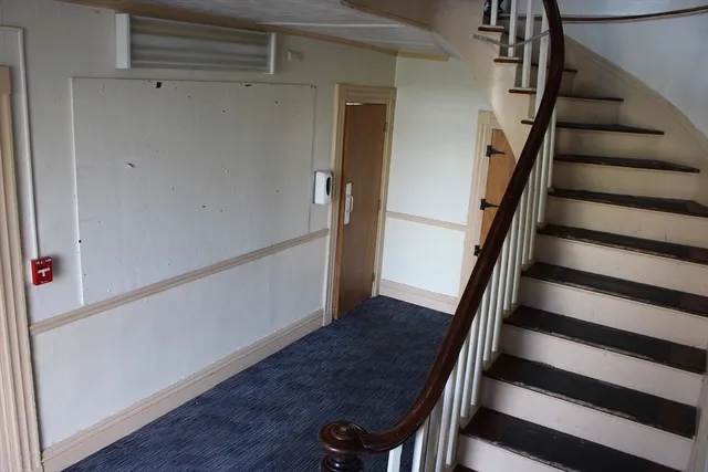 a view of entryway with wooden floor and stairs